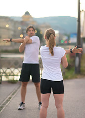 Image showing couple warming up before jogging