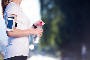 Image showing woman drinking  water after  jogging