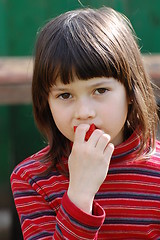 Image showing Girl eating red pepper