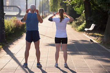 Image showing jogging couple planning running route  and setting music