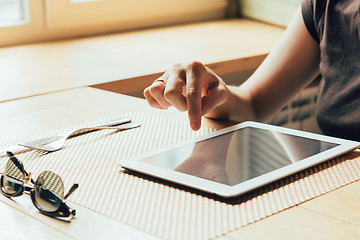 Image showing girl works on the tablet