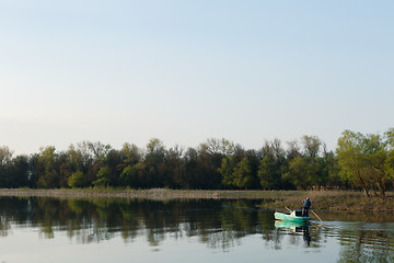 Image showing man sails on a boat