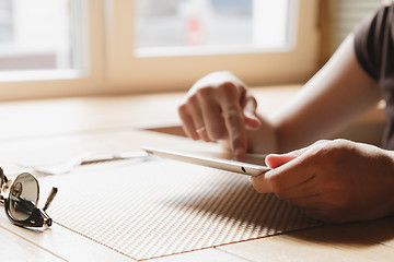 Image showing girl works on the tablet