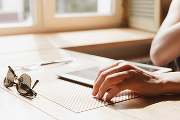 Image showing girl works on the tablet