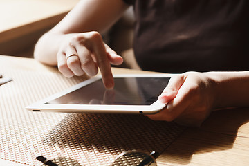 Image showing girl works on the tablet