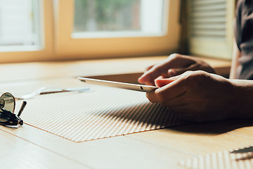 Image showing girl works on the tablet