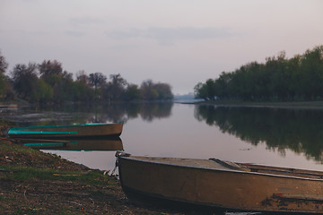 Image showing boats moored to the banks of the river