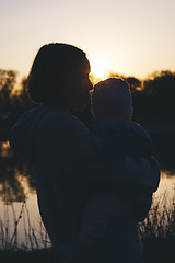 Image showing mom with child at sunset