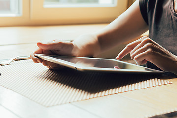 Image showing girl works on the tablet