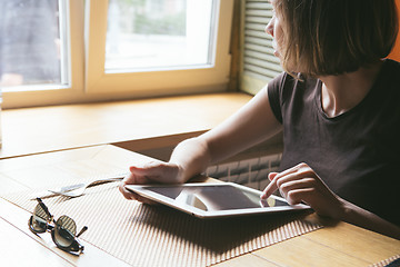 Image showing girl works on the tablet