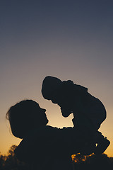 Image showing mom with child at sunset