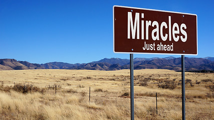 Image showing Miracles Just Ahead brown road sign