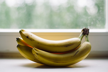 Image showing bunch of bananas on the window