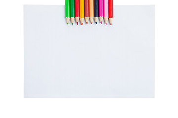 Image showing Colour pencils and paper blank isolated on white background 