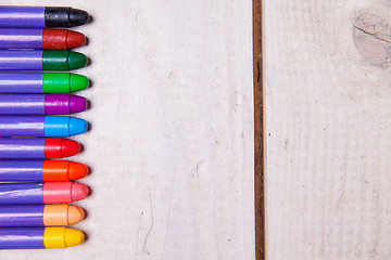 Image showing wax crayons on wood table