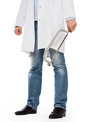 Image showing Crazy doctor is holding a big saw in his hands