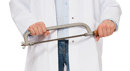 Image showing Crazy doctor is holding a big saw in his hands