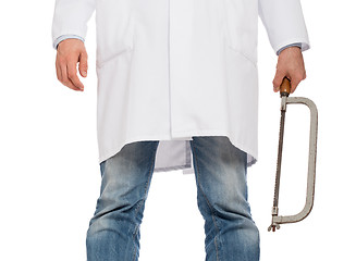 Image showing Crazy doctor is holding a big saw in his hands