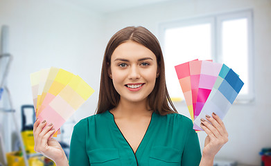 Image showing smiling young woman with color swatches