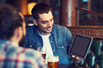 Image showing male friends with tablet pc drinking beer at bar