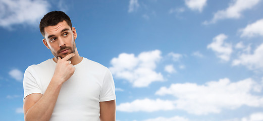 Image showing man thinking over blue sky and clouds background