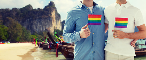 Image showing close up of male gay couple with rainbow flags