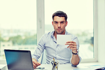 Image showing businessman showing blank paper card at office