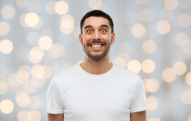 Image showing man with funny face over lights background