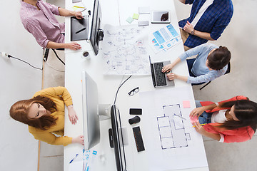 Image showing creative team with computers, blueprint at office