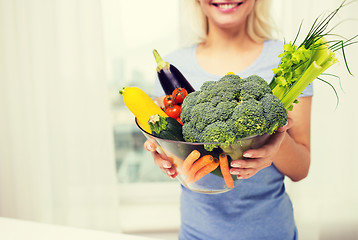 Image showing close up of woman holding vegetables in bowl