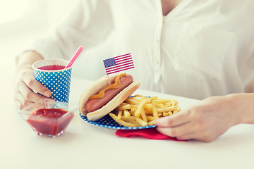 Image showing close up of woman eating hotdog and french fries