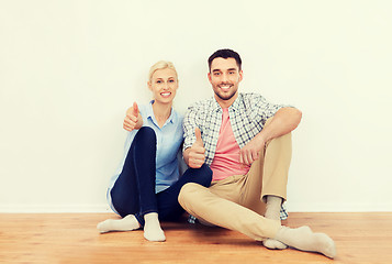 Image showing happy couple showing thumbs up at new home