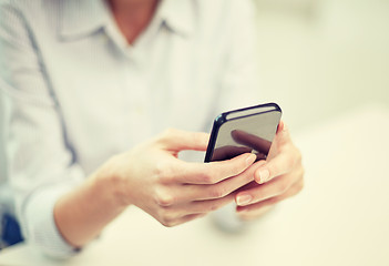 Image showing close up of woman texting on smartphone at office