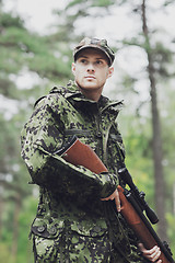 Image showing young soldier or hunter with gun in forest