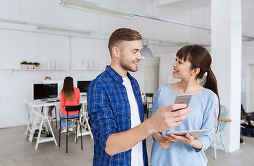 Image showing couple with smartphone and tablet pc at office