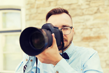 Image showing young hipster man with digital camera in city