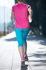 Image showing sporty woman running  on sidewalk