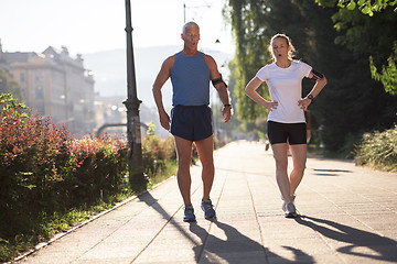 Image showing jogging couple planning running route  and setting music