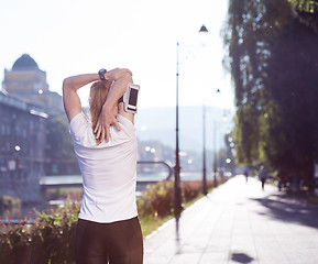 Image showing blonde woman  stretching before morning jogging