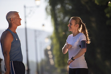 Image showing jogging couple planning running route  and setting music