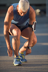 Image showing Man tying running shoes laces