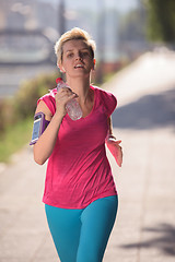 Image showing sporty woman running  on sidewalk