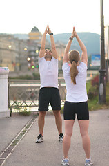 Image showing couple warming up before jogging