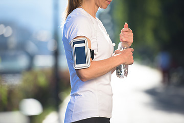 Image showing woman drinking  water after  jogging