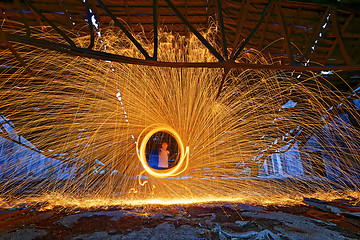 Image showing Burning Steel Wool spinning. Showers of glowing sparks from spin