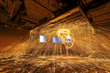 Image showing Burning Steel Wool spinning. Showers of glowing sparks from spin