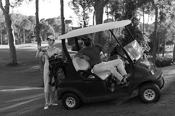 Image showing couple in buggy on golf course