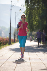 Image showing sporty woman running  on sidewalk