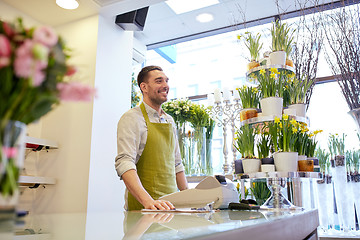 Image showing florist man or seller at flower shop counter