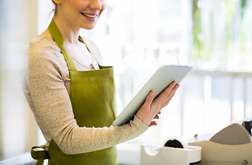 Image showing close up of woman with tablet pc at flower shop